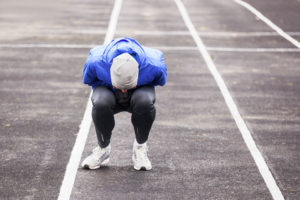 A runner doubled over in pain