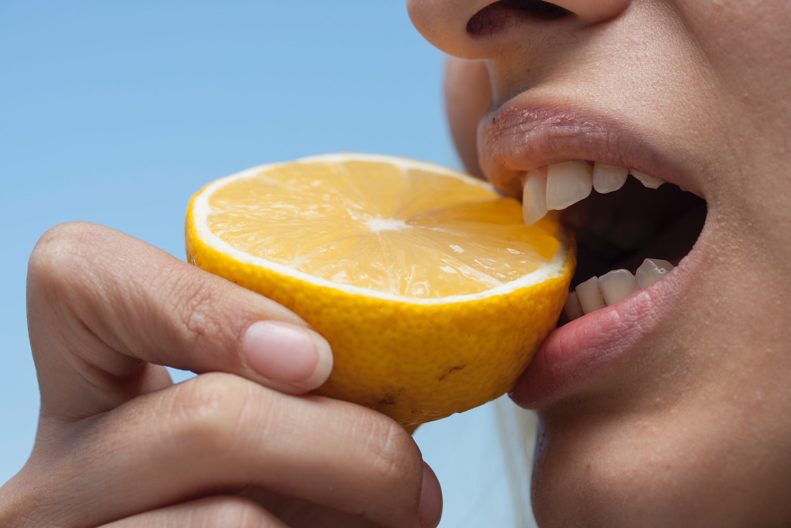 person holding orange fruit during daytime Fueling for Your First Triathlon